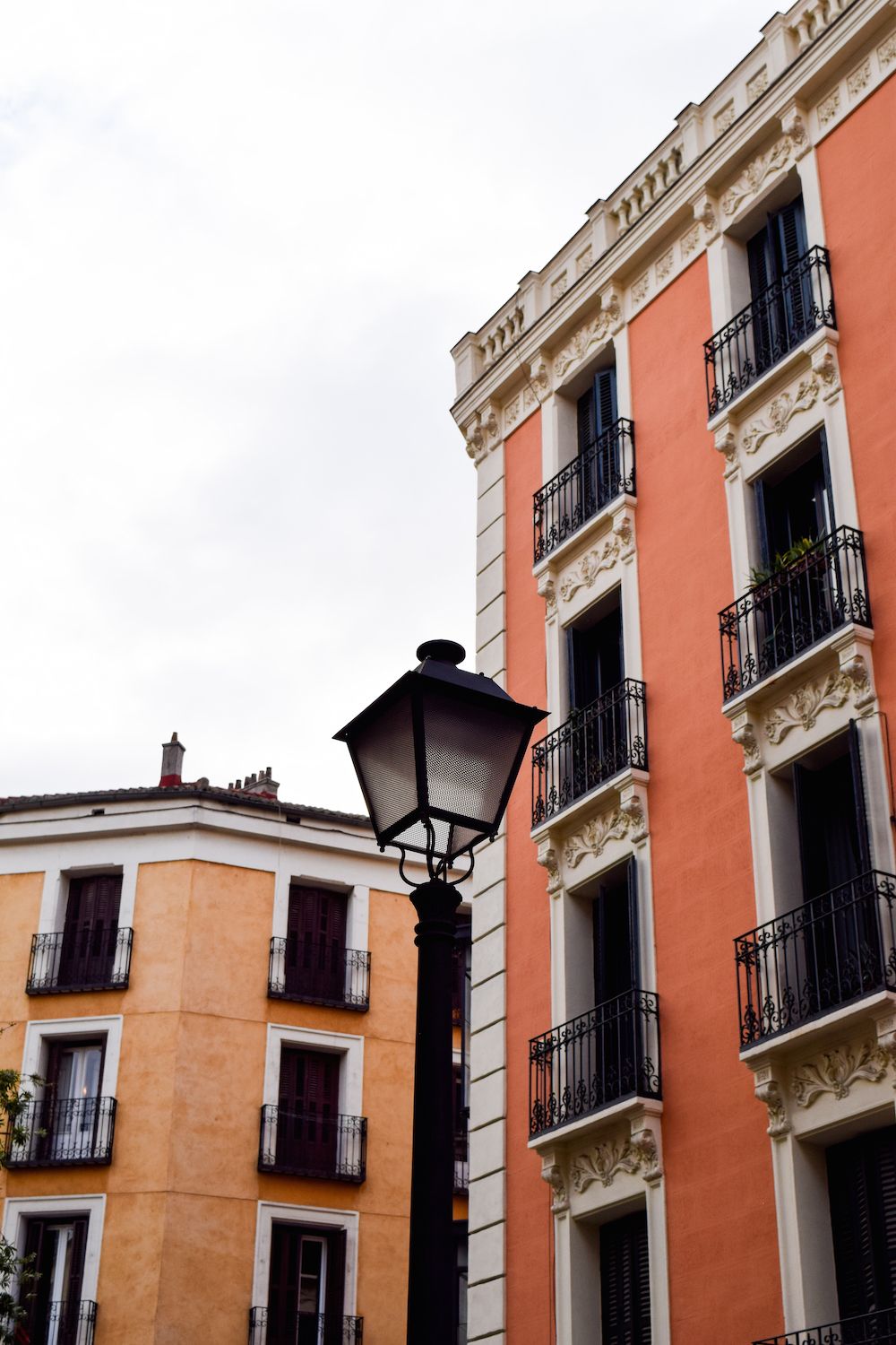 Orange and coral buildings in Malasaña, Madrid