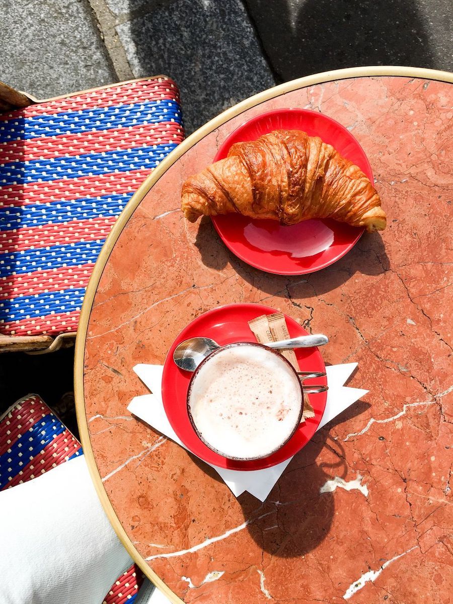 Morning coffee, croissant and newspaper at Le Bonaparte, Paris