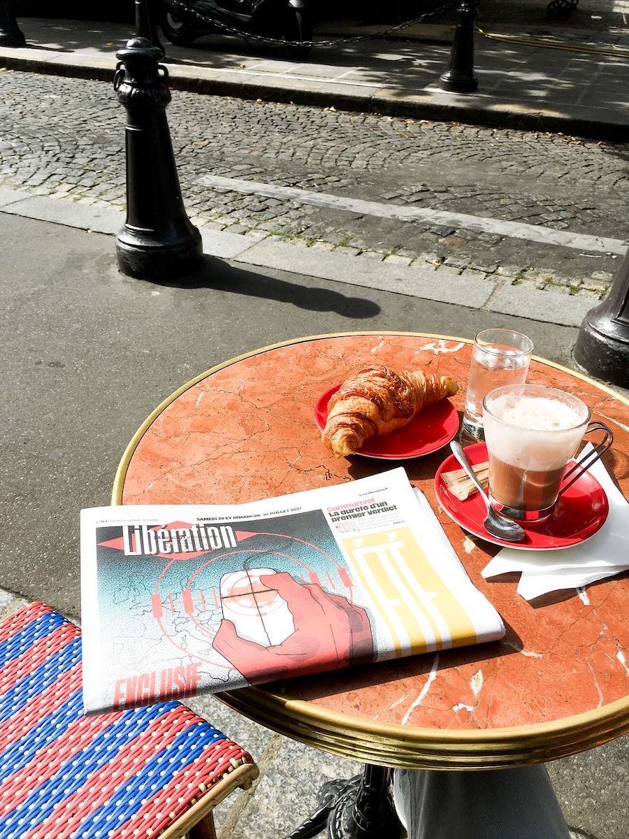 Morning coffee, croissant and newspaper in Paris