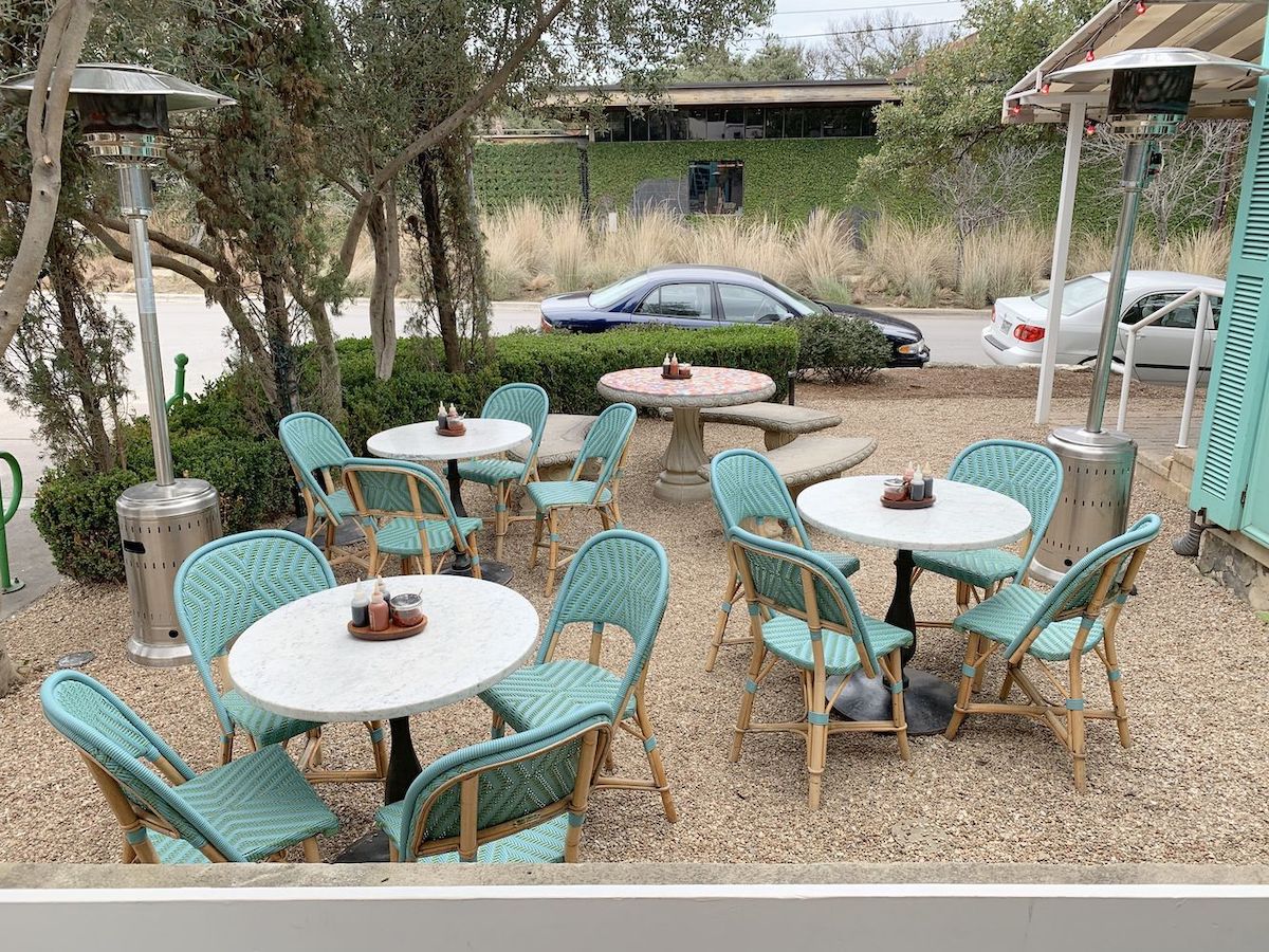 Patio with turquoise french bistro chairs at Elizabeth Street Cafe