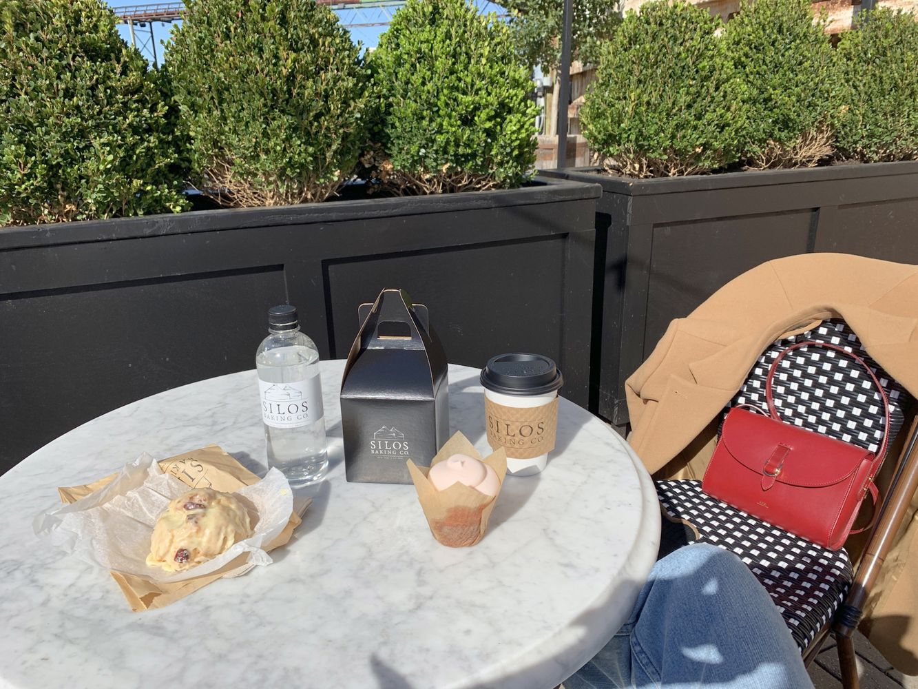 Strawberry Cupcake, Orange Scone and Coffee on the Marble Tables outside Magnolia Bakery