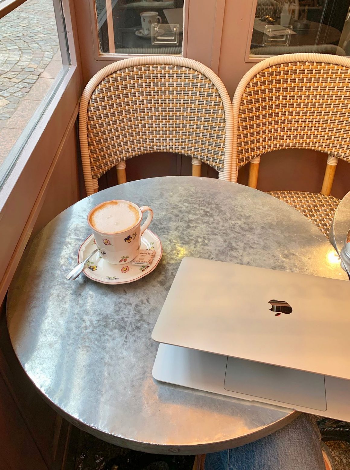 Why Self-Employment Is the Key to Traveling More - Laptop in a Paris Café